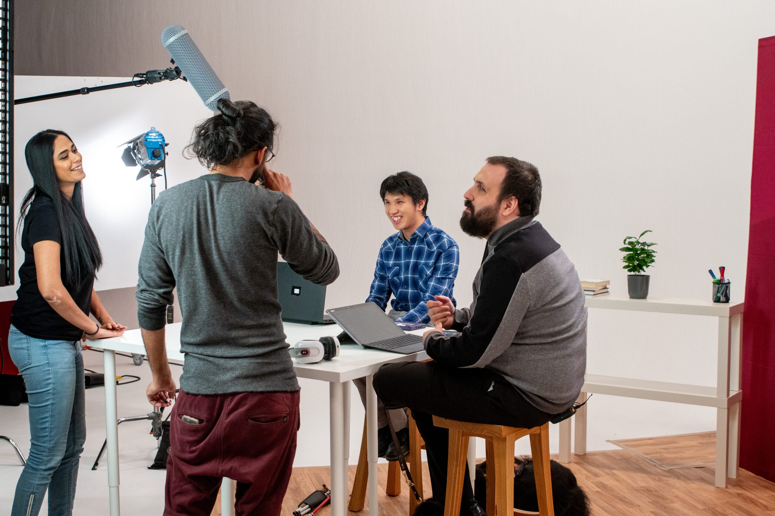 Abid, Alwar, Ka, and Sam talk behind the scenes during a video shoot in 2018